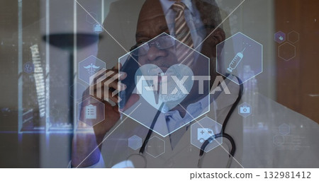 Senior doctor with stethoscope in lab coat speaking on smartphone in clinic, with medical holograms 132981412