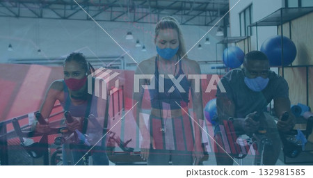 Fitness instructor timing masked participants pedaling on stationary bikes in gym, with stopwatch Fitness instructor timing masked participants pedaling on stationary bikes in gym, with stopwatch 132981585