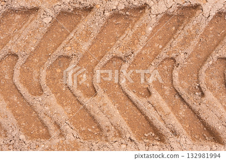 Footprint of car tire tread in a sand gravel road texture. Country road textured background. Backdrop for various ideas. Small stones land. Abstract sandy rough surface. Trendy effect. No people. Tyre Footprint of car tire tread in a sand gravel road texture. Country road textured background. Backdrop for various ideas. Small stones land. Abstract sandy rough surface. Trendy effect. No people. Tyre 132981994