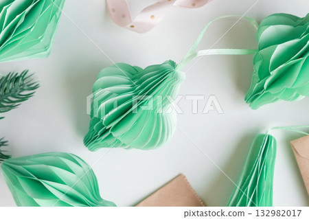 Paper Christmas honeycomb ornaments. Handmade foldable decor. Concept of winter creativity crafts. Trendy eco DIY. Scandinavian Modern decoration. Top view Boho Style Design. Structural 3d Origami Toy 132982017