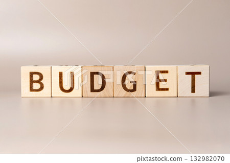 The word BUDGET on wooden cubes on a beige neutral studio background. Copy Space. Written. Text words matter. Conceptual Photo. Budget planning symbol. Write idea success solution concept. The word BUDGET on wooden cubes on a beige neutral studio background. Copy Space. Written. Text words matter. Conceptual Photo. Budget planning symbol. Write idea success solution concept. 132982070