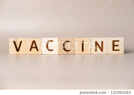 The word VACCINATION on wooden cubes on a beige neutral studio background. Copy Space. Written. Text words matter. Human health. Vaccination concept. Coronavirus, COVID-19, MPOX, Flu virus protection The word VACCINATION on wooden cubes on a beige neutral studio background. Copy Space. Written. Text words matter. Human health. Vaccination concept. Coronavirus, COVID-19, MPOX, Flu virus protection 132982083