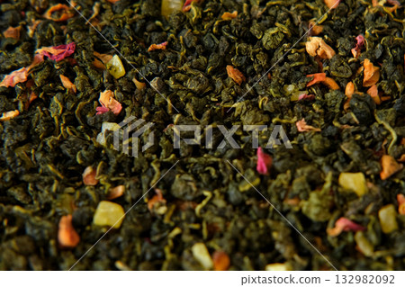 Loose Leaf Mango Pineapple Fruit Tea Wallpaper. Mix Black and Green Dry Tea Leaves. Close Up, Macro. Top View. Texture. Dried Tea is Spinning, Rotating. Abstract Food and Drink Background. Full Frame. Loose Leaf Mango Pineapple Fruit Tea Wallpaper. Mix Black and Green Dry Tea Leaves. Close Up, Macro. Top View. Texture. Dried Tea is Spinning, Rotating. Abstract Food and Drink Background. Full Frame. 132982092