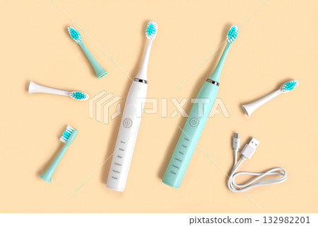 Toothbrushes on a beige neutral pastel color studio background. Top View Flat Lay, Copy Space. Dental Care Supplies. Oral Hygiene Gum Health, Healthy Teeth. Modern Dental Tooth Brush Set. Clean teeth 132982201