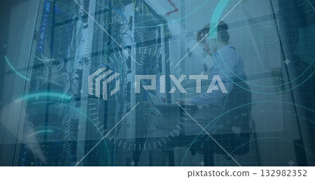 Network technicians in shirts inspecting switches and cables in data center with laptop, copy space 132982352