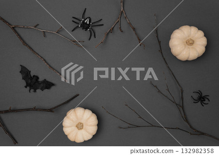 Halloween black background with bats, spiders, pumpkins and twigs. Modern Holiday design. Halloween party border on Dark Gray colour. Flat lay, top view, copy space. Thanksgiving fall decoration. 2022 Halloween black background with bats, spiders, pumpkins and twigs. Modern Holiday design. Halloween party border on Dark Gray colour. Flat lay, top view, copy space. Thanksgiving fall decoration. 2022 132982358