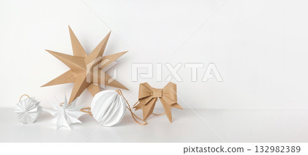 Christmas Paper Star and Ball Decoration. Handmade Christmas Nordic Decor on a Light Background against the Wall. Boho, Scandinavian Style Design. DIY. Minimal Ornament. Structural Origami. Zero Waste Christmas Paper Star and Ball Decoration. Handmade Christmas Nordic Decor on a Light Background against the Wall. Boho, Scandinavian Style Design. DIY. Minimal Ornament. Structural Origami. Zero Waste 132982389