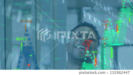 Laughing man in business casual shirt interacting with transparent digital display at modern office Laughing man in business casual shirt interacting with transparent digital display at modern office 132982447