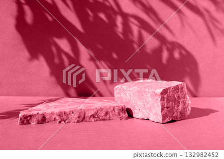 Podiums for cosmetic presentation. Two Abstract minimal geometrical forms. Natural stone, plant shadow. Scene to show product. Showcase, display. Trendy sunlight. 3D. Photo toned by Viva Magenta color 132982452