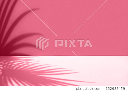 Minimal abstract background with shadow of tropical palm leaves. Presentation of cosmetic product. Premium podium. Viva Magenta colored wall and white table. Showcase, display case, Front view. Mockup Minimal abstract background with shadow of tropical palm leaves. Presentation of cosmetic product. Premium podium. Viva Magenta colored wall and white table. Showcase, display case, Front view. Mockup 132982459