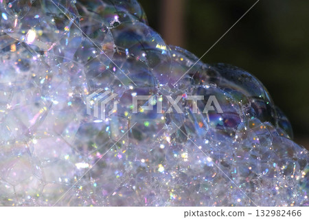 A Lot of Soap Bubbles are Bursting. Bubbles Surface on Nature Background. Texture of Big Foam. Creative concept of dreaming, happiness and magic. Abstract symbol of childhood, fantasy, freedom. A Lot of Soap Bubbles are Bursting. Bubbles Surface on Nature Background. Texture of Big Foam. Creative concept of dreaming, happiness and magic. Abstract symbol of childhood, fantasy, freedom. 132982466
