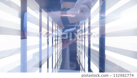 Gripping smartphone, person in dark sportswear leaning on support bar at tech lab, with LED panels Gripping smartphone, person in dark sportswear leaning on support bar at tech lab, with LED panels 132982774