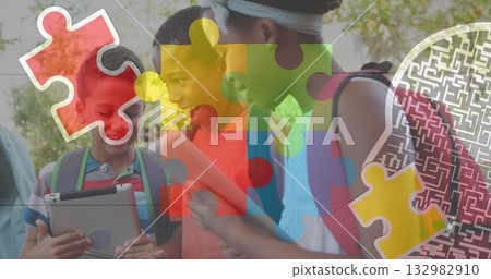 Leaning four students wearing backpacks in sunlit park, holding tablet notebook papers 132982910