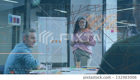 Presenting woman wearing business casual gesturing at digital charts on glass wall in modern office 132983006