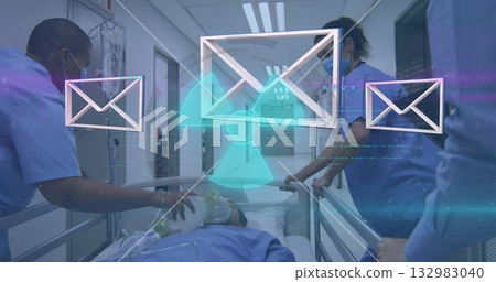 Medical team in blue scrubs pushing gurney in hospital corridor with mail icons and hazard overlay 132983040