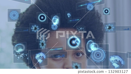 Interacting mid adult woman manipulating holographic interface elements in tech lab, with data bars 132983127