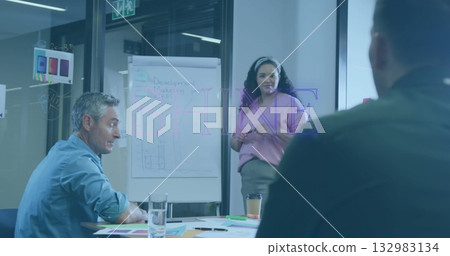 Presenting mid adult woman by flipchart in meeting room, with sticky notes, papers, coffee cup 132983134