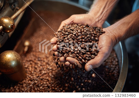 Cooling tray with brown roasted coffee beans. Coffee production industry of Africa. Fresh coffee grains in barista hands. Roaster background. Closeup roasting machine. Modern equipment grain chiller 132983460