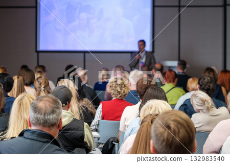 Business conference with speaker presenting to audience in a meeting room during seminar and training session Business conference with speaker presenting to audience in a meeting room during seminar and training session 132983540