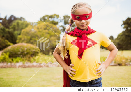 Female child posing in park wearing red eye mask, scarf, cape, yellow t-shirt and jeans Female child posing in park wearing red eye mask, scarf, cape, yellow t-shirt and jeans 132983782