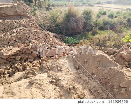 Demolished Old Bridge with Scattered Bricks and Earth Preparing for New Construction Reflecting Rural Development and Modern Engineering Under Open Sky with Vegetation and Future Infrastructure Plans Demolished Old Bridge with Scattered Bricks and Earth Preparing for New Construction Reflecting Rural Development and Modern Engineering Under Open Sky with Vegetation and Future Infrastructure Plans 132984766