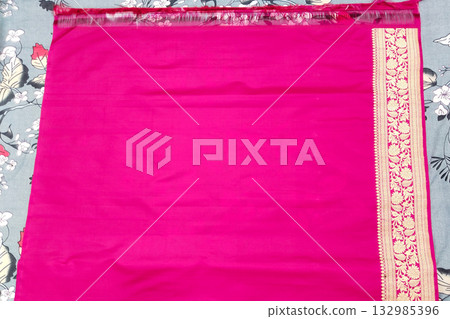 Elegant magenta Banarasi silk saree with contrasting purple pallu and rich golden embroidery on the borders, ideal for traditional Indian weddings, cultural celebrations, and ethnic festive fashion Elegant magenta Banarasi silk saree with contrasting purple pallu and rich golden embroidery on the borders, ideal for traditional Indian weddings, cultural celebrations, and ethnic festive fashion 132985396