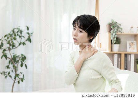 A young woman with stiff shoulders A young woman with stiff shoulders 132985919