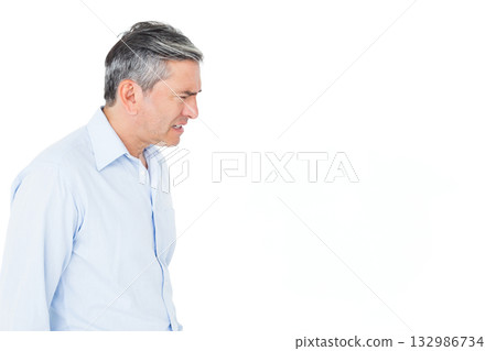 Man standing wearing light blue shirt in studio showing tense focus facing right, copy space Man standing wearing light blue shirt in studio showing tense focus facing right, copy space 132986734