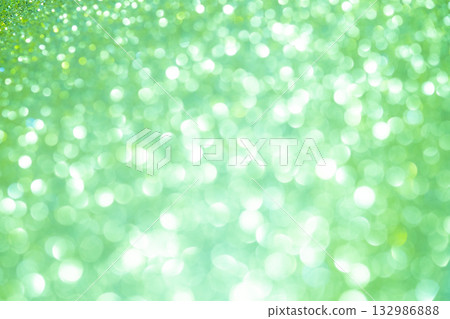 Light green colored large and small bokeh glitter background material 132986888