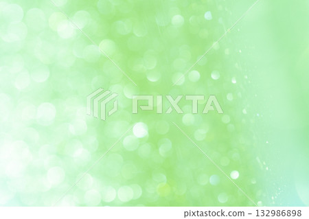 Light green colored large and small bokeh glitter background material 132986898