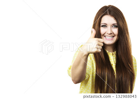 Cheerful woman showing thumb up Cheerful woman showing thumb up 132988043