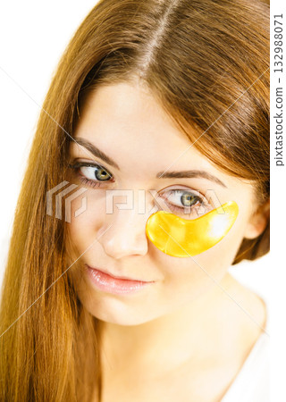 Woman with gold patches under eyes 132988071