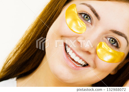 Woman with gold patches under eyes 132988072