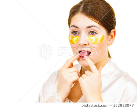Woman with gold patches under eyes Woman with gold patches under eyes 132988077