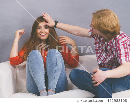 Happy man and woman sitting on sofa Happy man and woman sitting on sofa 132988108