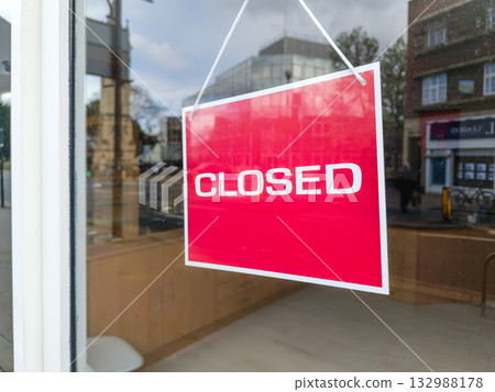 Red 'Closed' sign hanging on glass door of empty shopfront Red 'Closed' sign hanging on glass door of empty shopfront 132988178