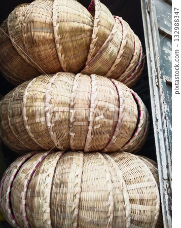 Large traditional handmade bamboo baskets (tokri or dauri) arranged for sale in rural India, showing indigenous craftsmanship and utility in village markets Large traditional handmade bamboo baskets (tokri or dauri) arranged for sale in rural India, showing indigenous craftsmanship and utility in village markets 132988347