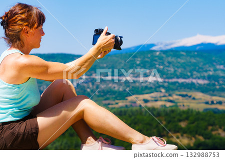Woman take photo on mountain nature in France 132988753