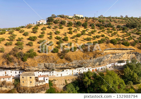 Unique whitewashed village built into dramatic rock formations, offers one of Andalusia most picturesque sights in Setenil de las Bodegas, Spain Unique whitewashed village built into dramatic rock formations, offers one of Andalusia most picturesque sights in Setenil de las Bodegas, Spain 132988794