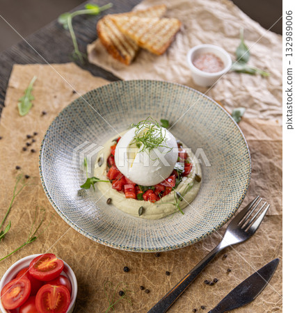 Burrata cheese resting on hummus Burrata cheese resting on hummus 132989006