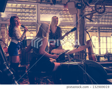 Music band performing on stage. 132989019