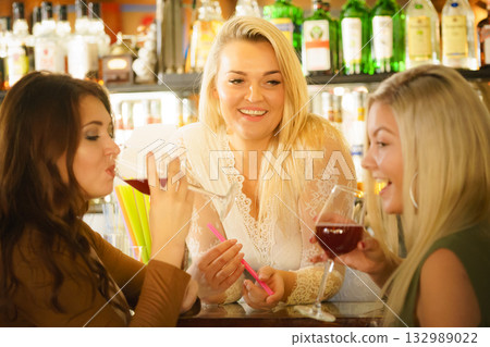 Girls with alcohol glasses in pub club Girls with alcohol glasses in pub club 132989022