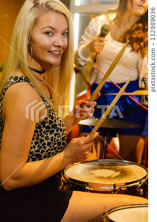 Woman singing, band playing instruments. 132989036