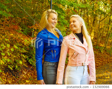 Two women walking in autumn park 132989066
