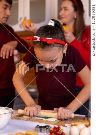 The family is joyfully preparing Christmas cookies together The family is joyfully preparing Christmas cookies together 132989381