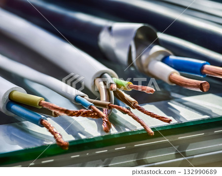 Variety of electrical wires and cables showing different colors and types in a detailed view on the workbench 132990689