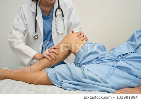 Doctor checking Asian elderly woman patient with scar knee replacement surgery in hospital. Doctor checking Asian elderly woman patient with scar knee replacement surgery in hospital. 132991984