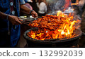 India Street Food, Street vendor grilling smoky tandoori chicken skewers over an open flame 132992039