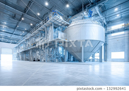 Industrial farm agricultural silos for storage and drying of grains, wheat, corn, soy, sunflower with sunlight. Large metal grain tanks and processing equipment in modern facility. Agriculture, food. Industrial farm agricultural silos for storage and drying of grains, wheat, corn, soy, sunflower with sunlight. Large metal grain tanks and processing equipment in modern facility. Agriculture, food. 132992641