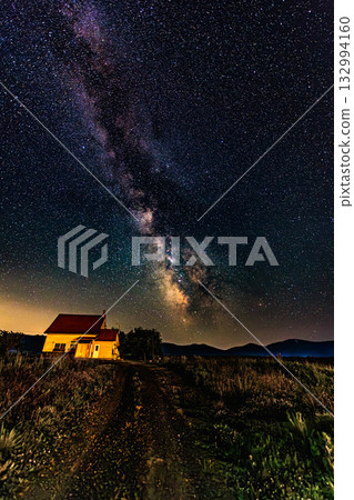A starry sky and a small house at the foot of the mountain A starry sky and a small house at the foot of the mountain 132994160